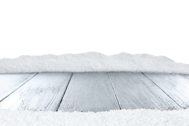 Photo of Heap of snow on grey wooden surface against white background