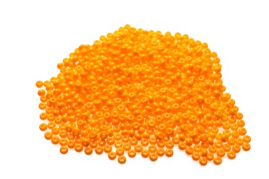Photo of Pile of orange beads on white background