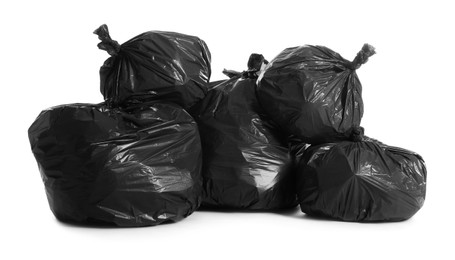 Black trash bags full of garbage on white background