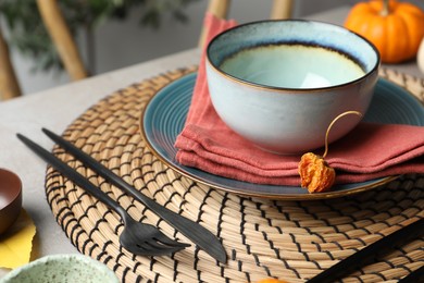 Seasonal table setting with autumn decor in dining room, closeup