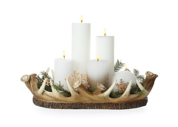 Beautiful burning candles with Christmas decor in basket on white background