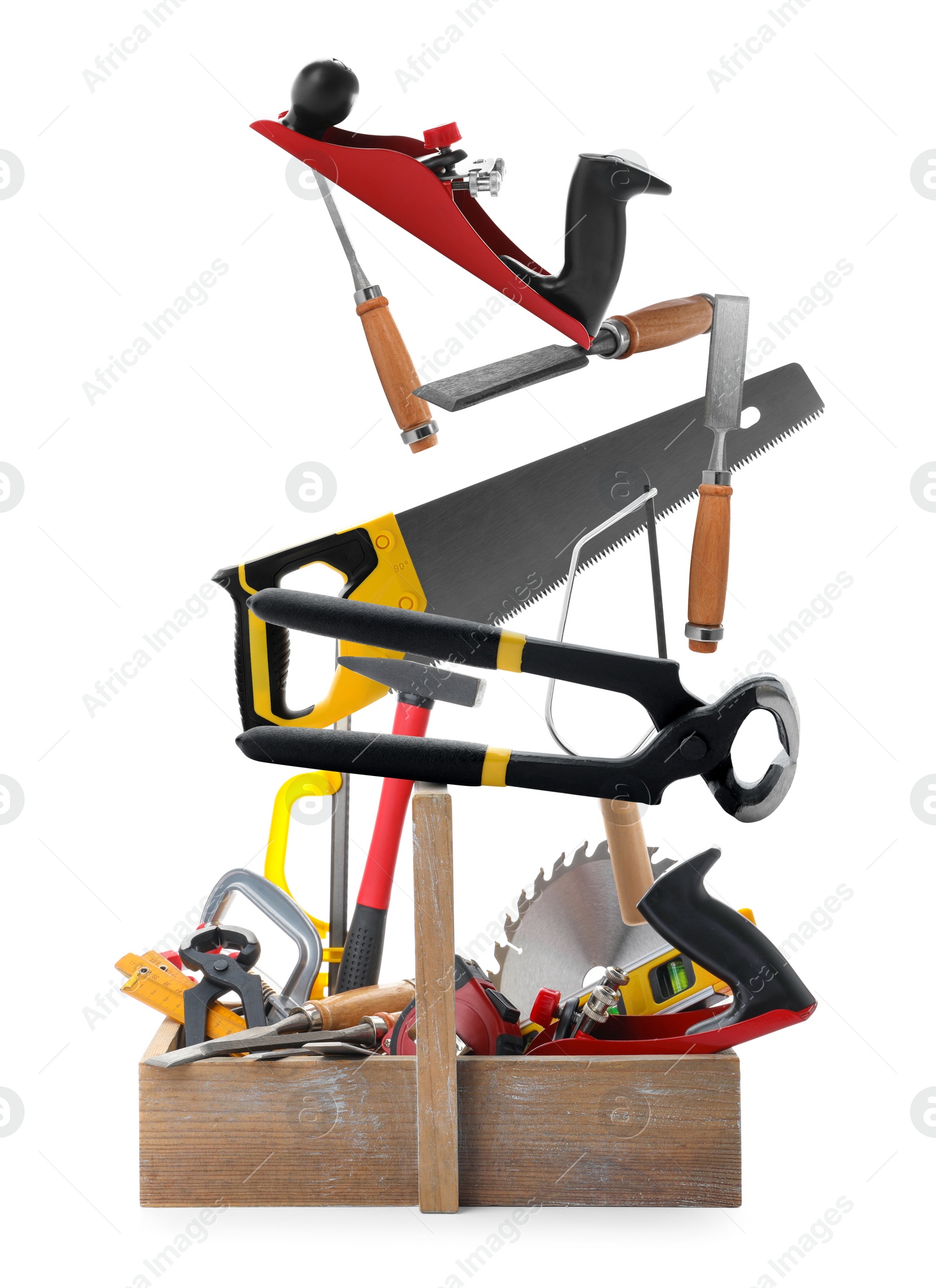 Image of Different carpenter's tools falling into wooden box on white background