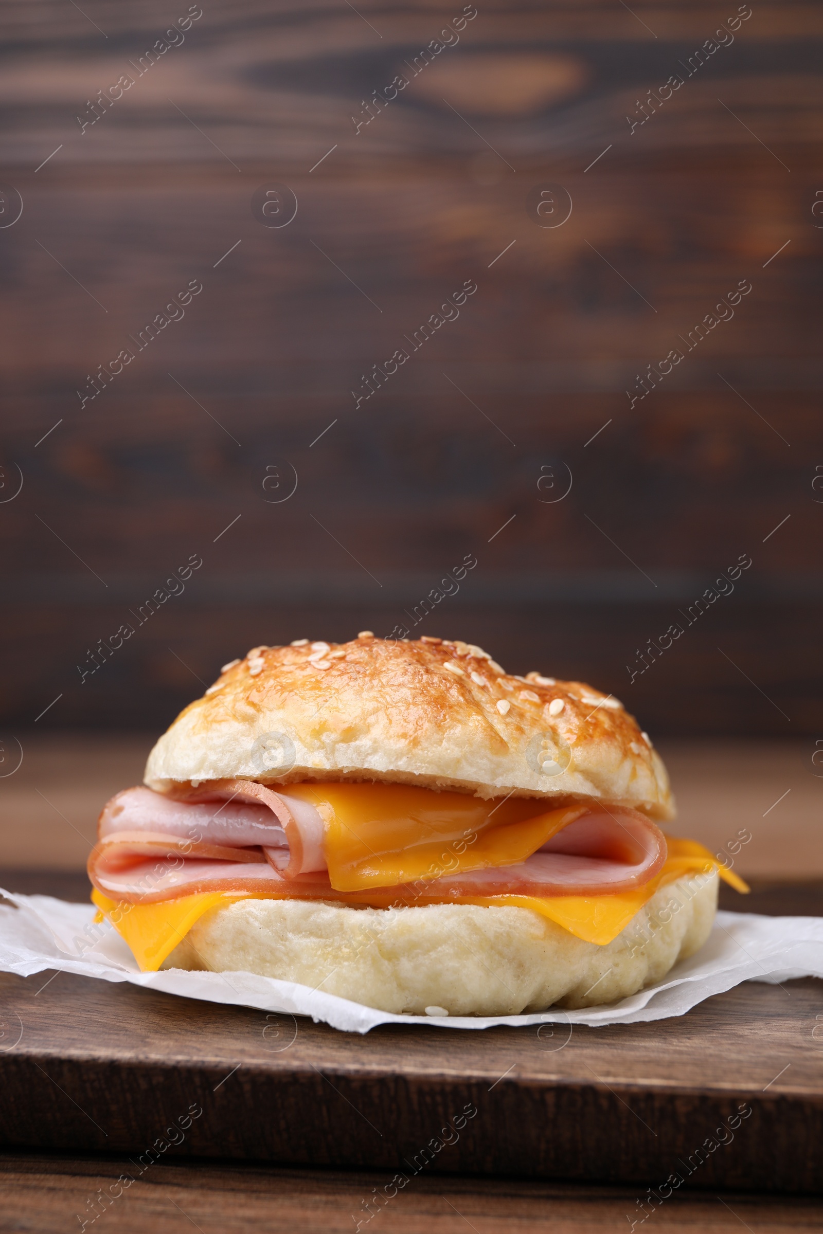 Delicious bagel with ham and cheese on table. Space for text Photo of Delicious bagel with ham and cheese on table. Space for text