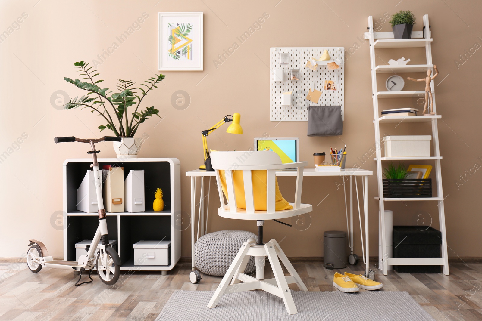 Photo of Modern laptop on desk in room. Home workplace