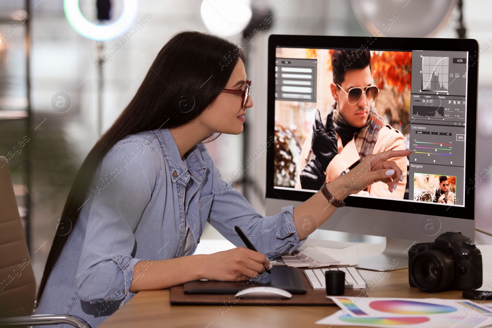 Photo of Professional retoucher working on computer in office