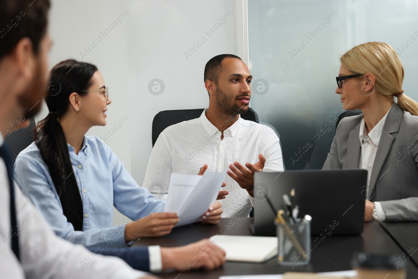 Photo of Lawyers working together at table in office