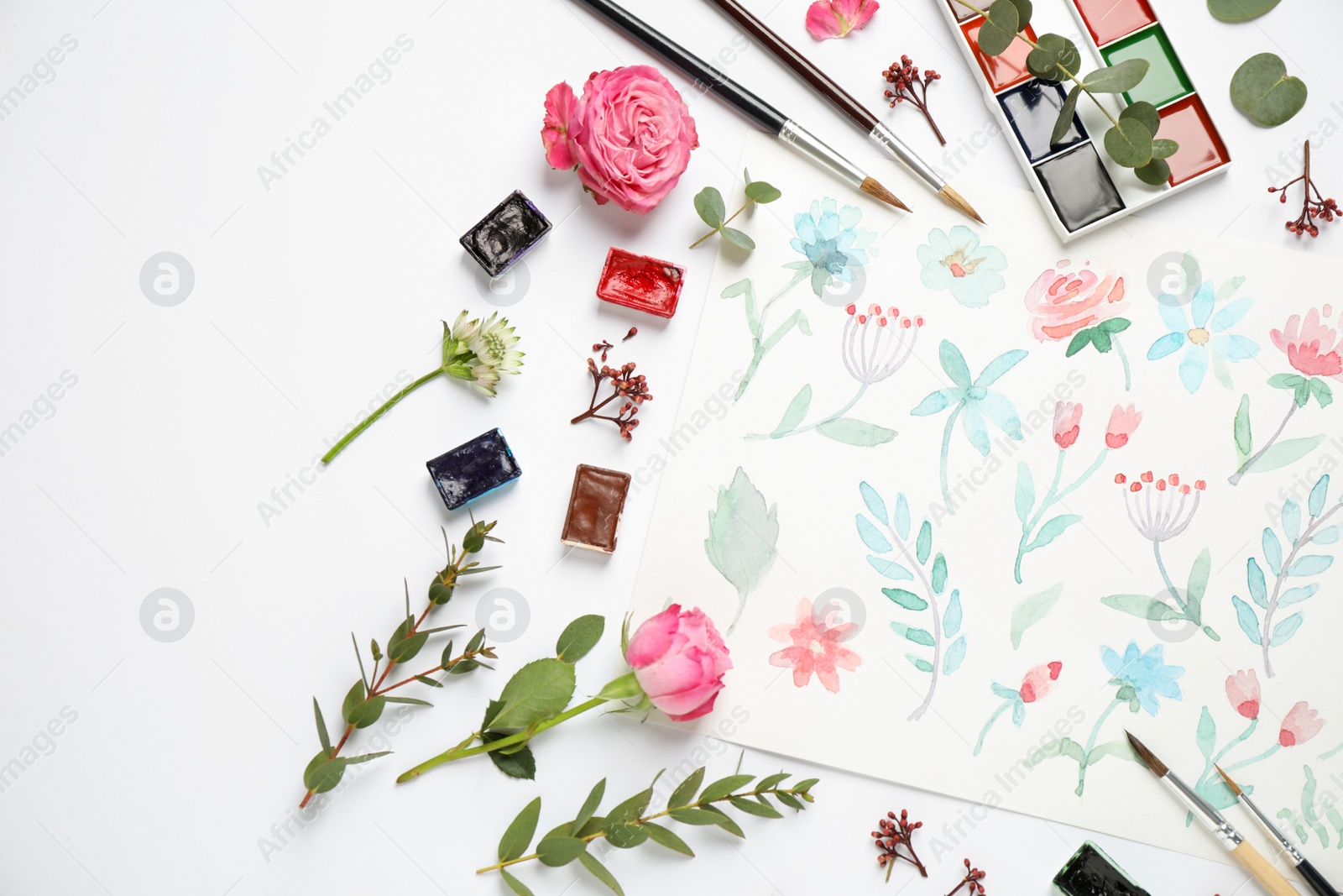 Photo of Flat lay composition with watercolor paints and floral picture on white background