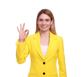 Photo of Beautiful happy businesswoman showing OK gesture on white background