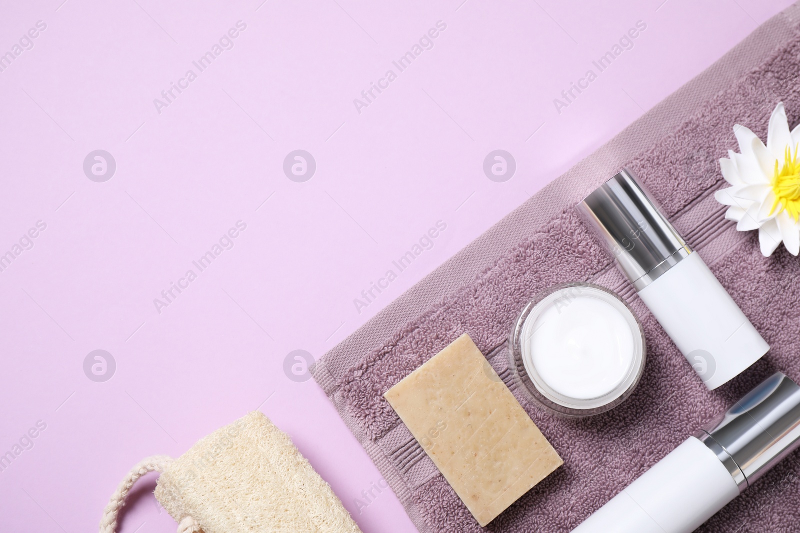 Photo of Flat lay composition with different cosmetic products on lilac background. Space for text