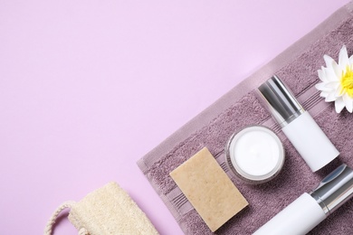 Flat lay composition with different cosmetic products on lilac background. Space for text