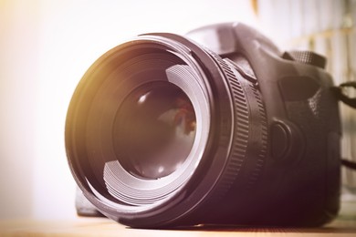 Image of Professional camera on table, closeup. Photographer's equipment