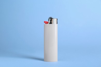 Photo of Stylish small pocket lighter on white background