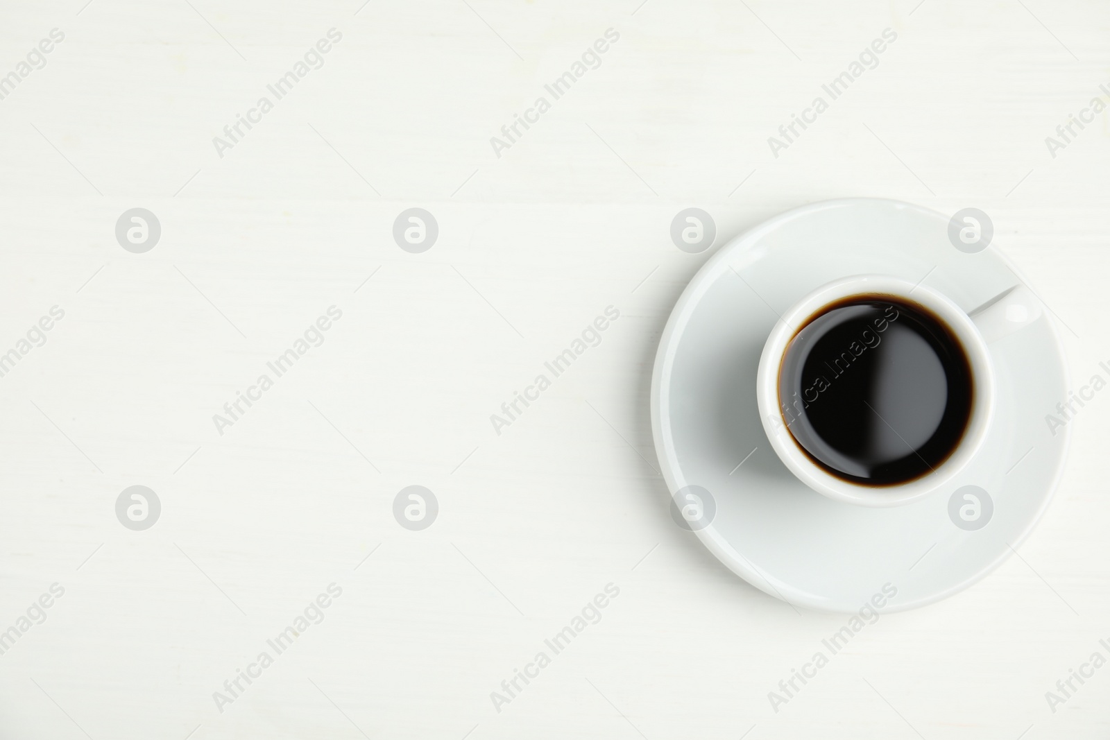Photo of Cup of hot aromatic espresso on white background, top view
