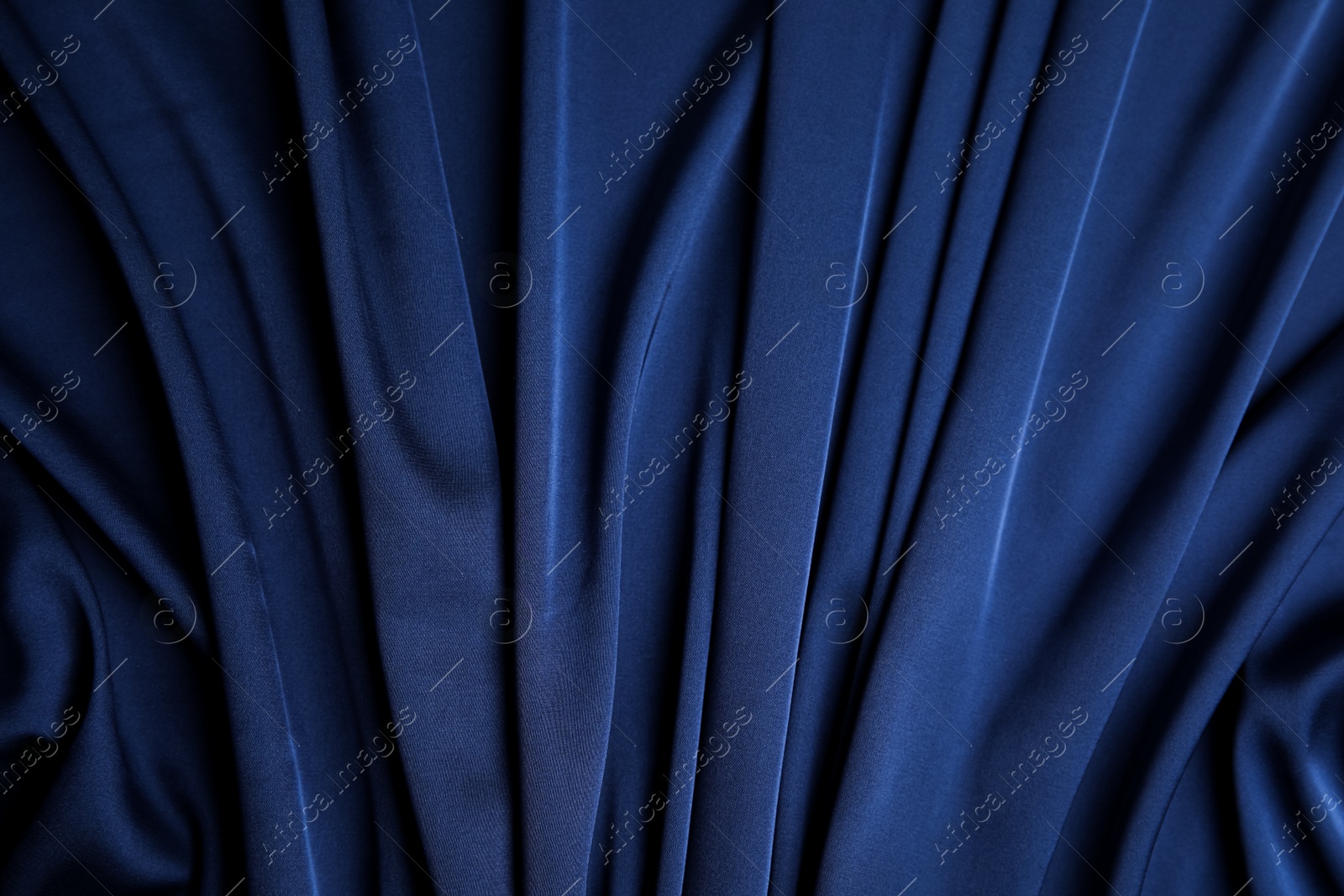 Photo of Crumpled dark blue silk fabric as background, top view