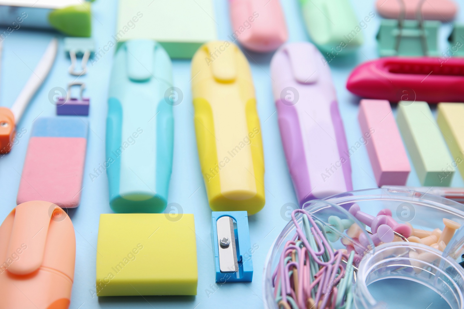 Photo of Many different school stationery on light blue background, closeup. Back to school