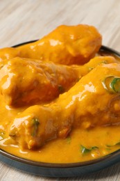 Tasty chicken curry on wooden table, closeup