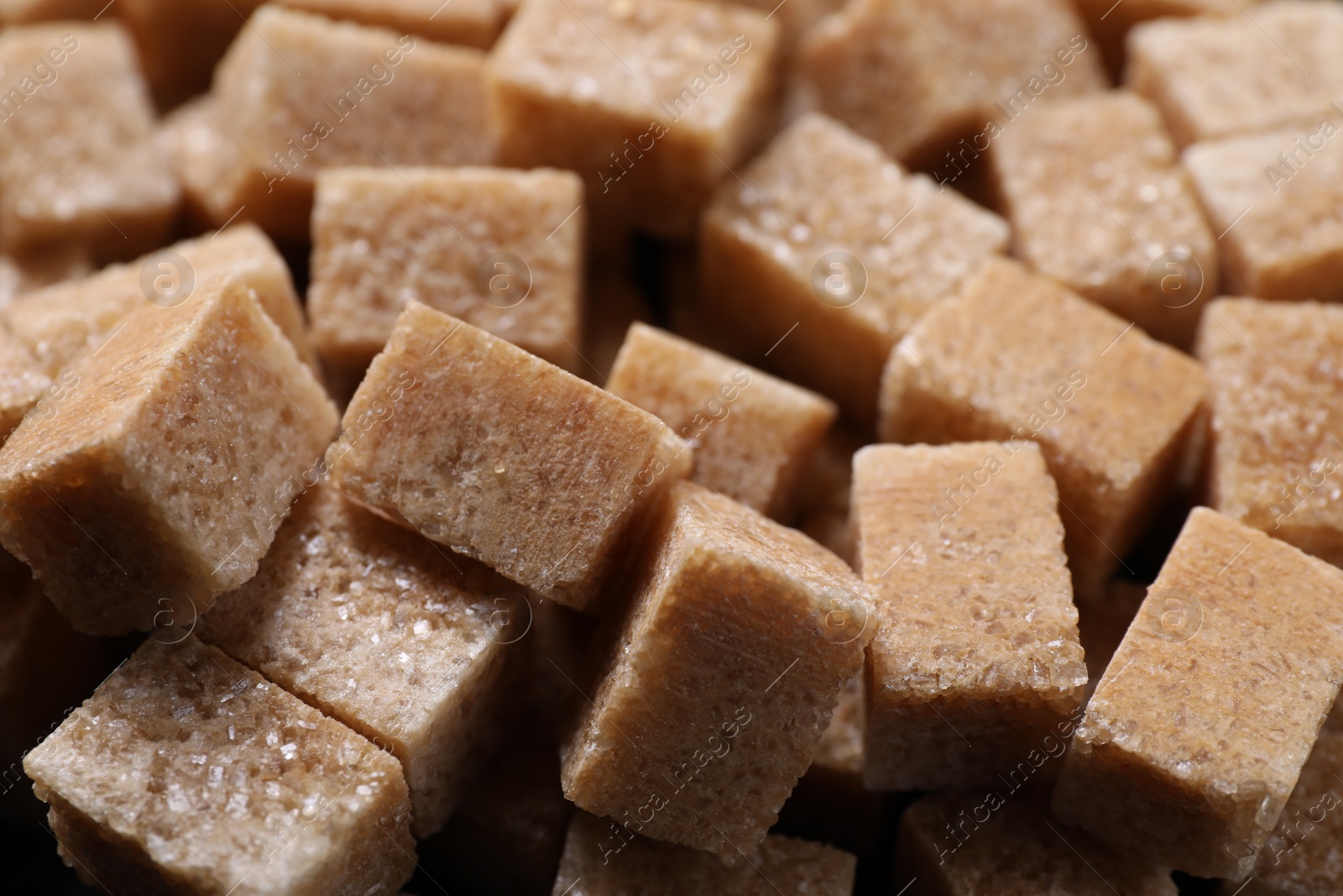 Photo of Many brown sugar cubes as background, closeup