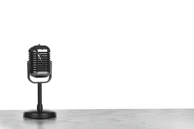 Retro microphone on table against white background. Space for text