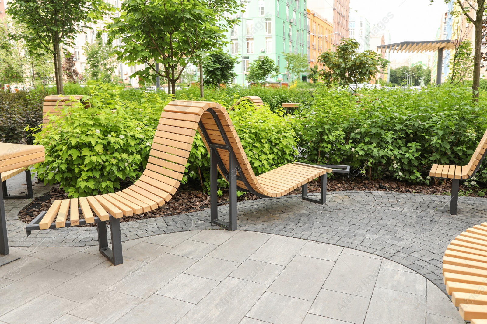 Photo of Park with wooden benches in city center