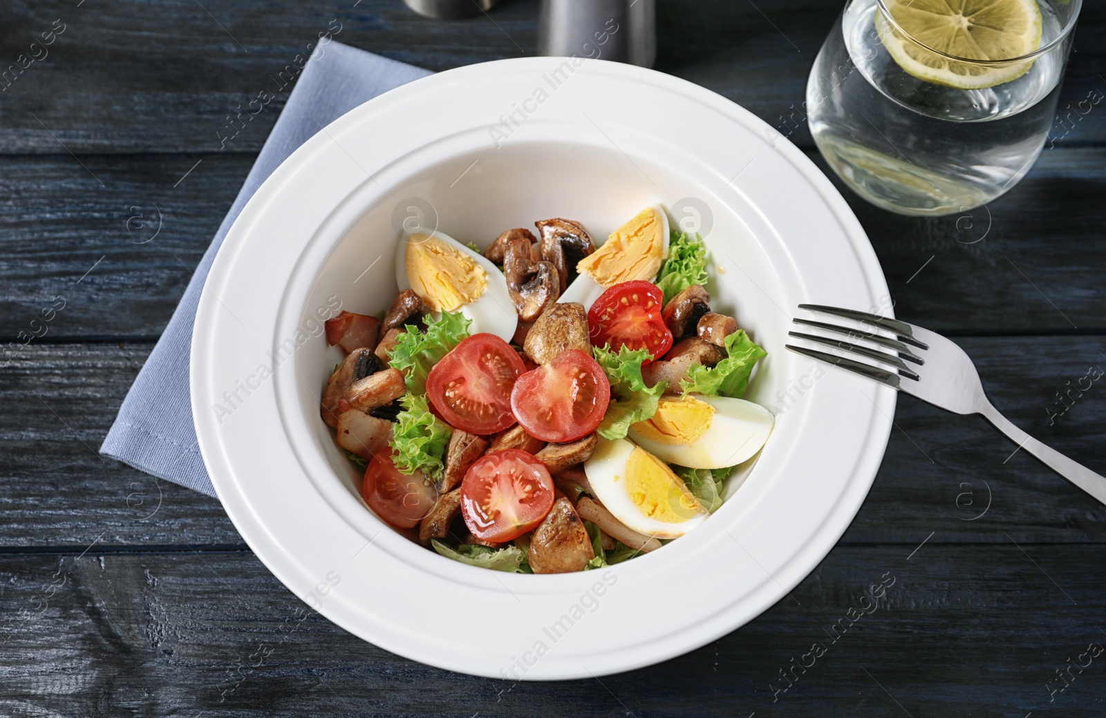 Photo of Plate with delicious fresh salad on table