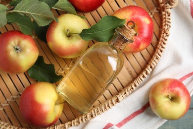 Photo of Natural apple vinegar and fresh fruits on table, flat lay