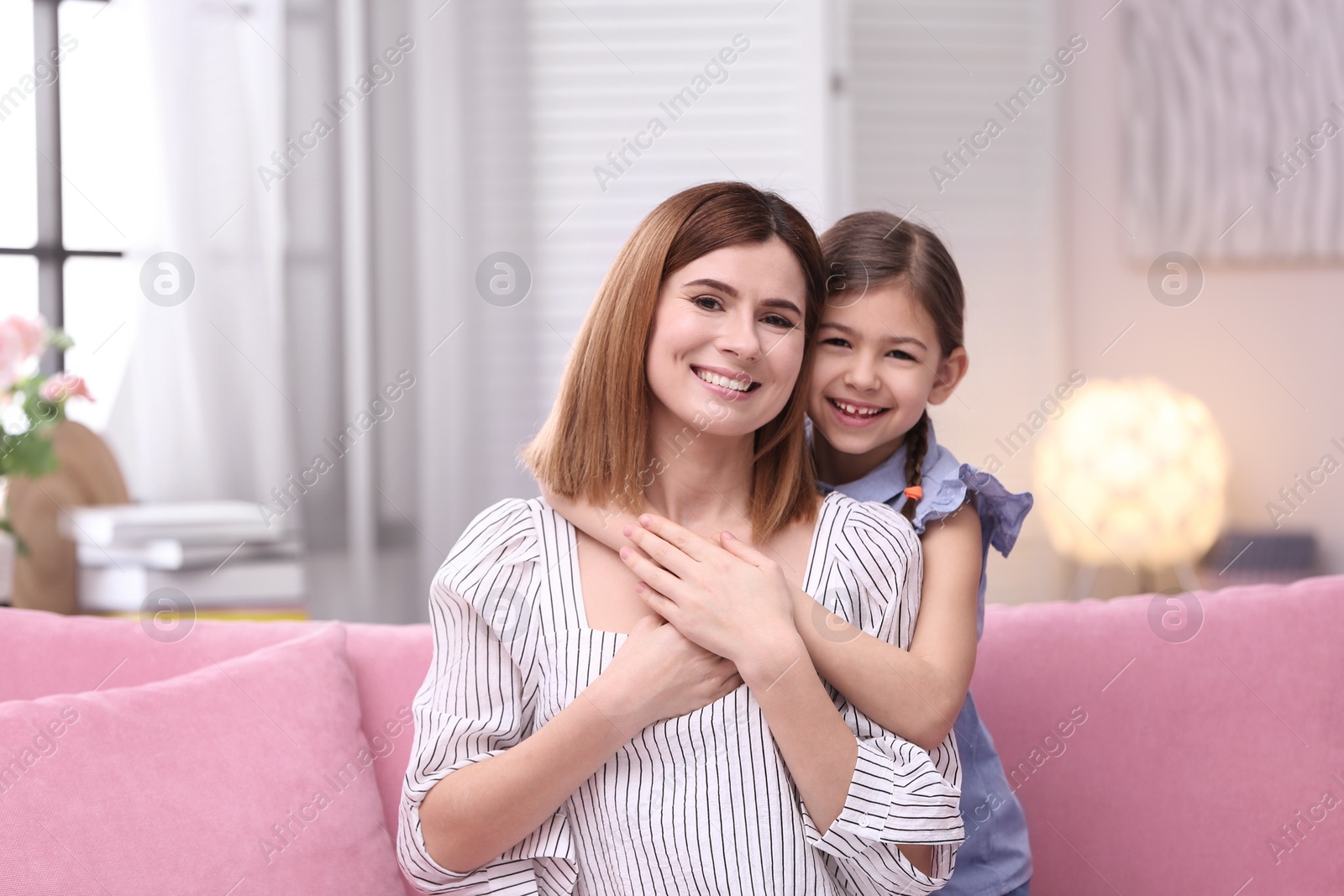 Photo of Happy woman and daughter together at home