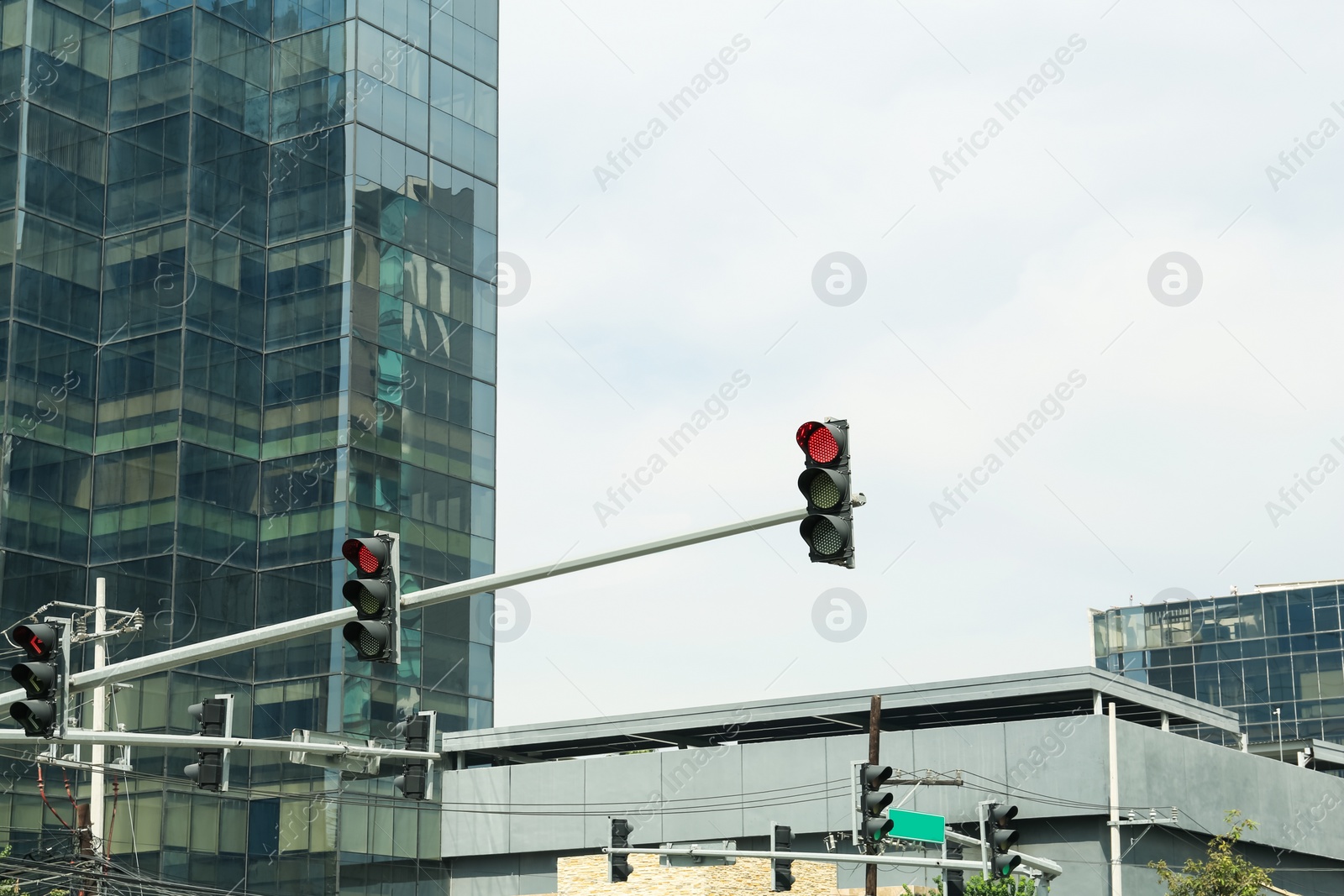 Photo of Overhead traffic lights in city. Road rules