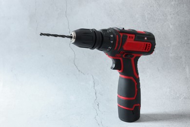 Photo of Modern cordless electric screwdriver on light table