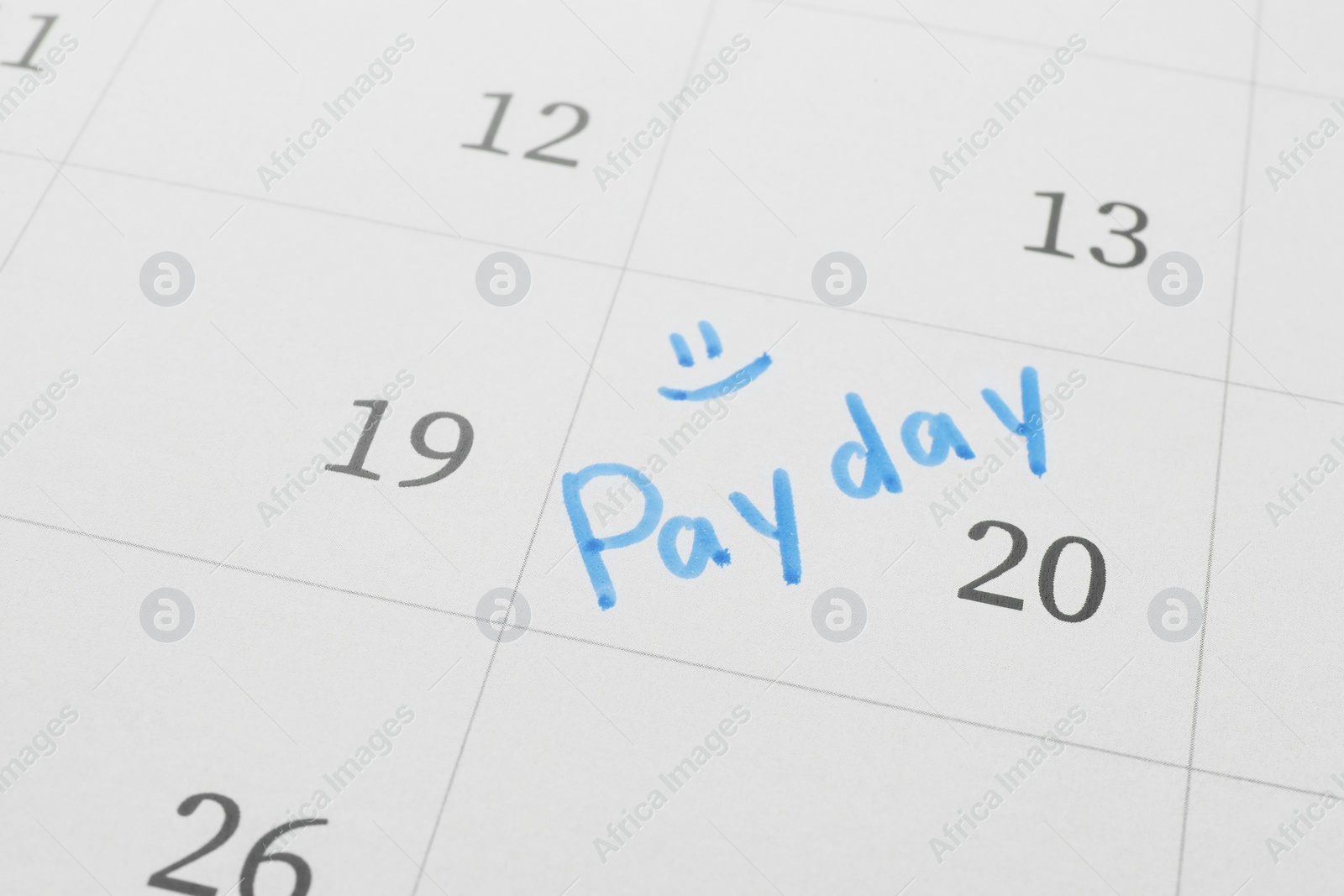 Photo of Calendar page with marked payday date as background, closeup