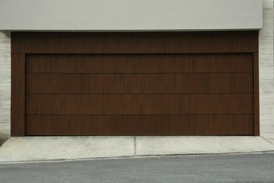 Photo of Building with brown sectional garage door outdoors