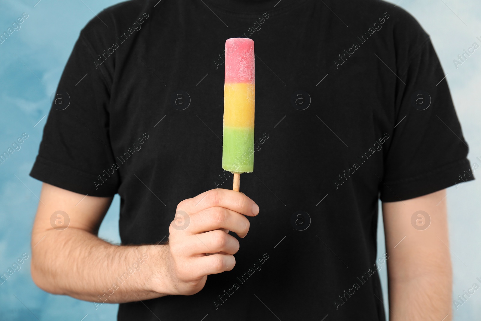 Photo of Man holding yummy ice cream, closeup. Focus on hand