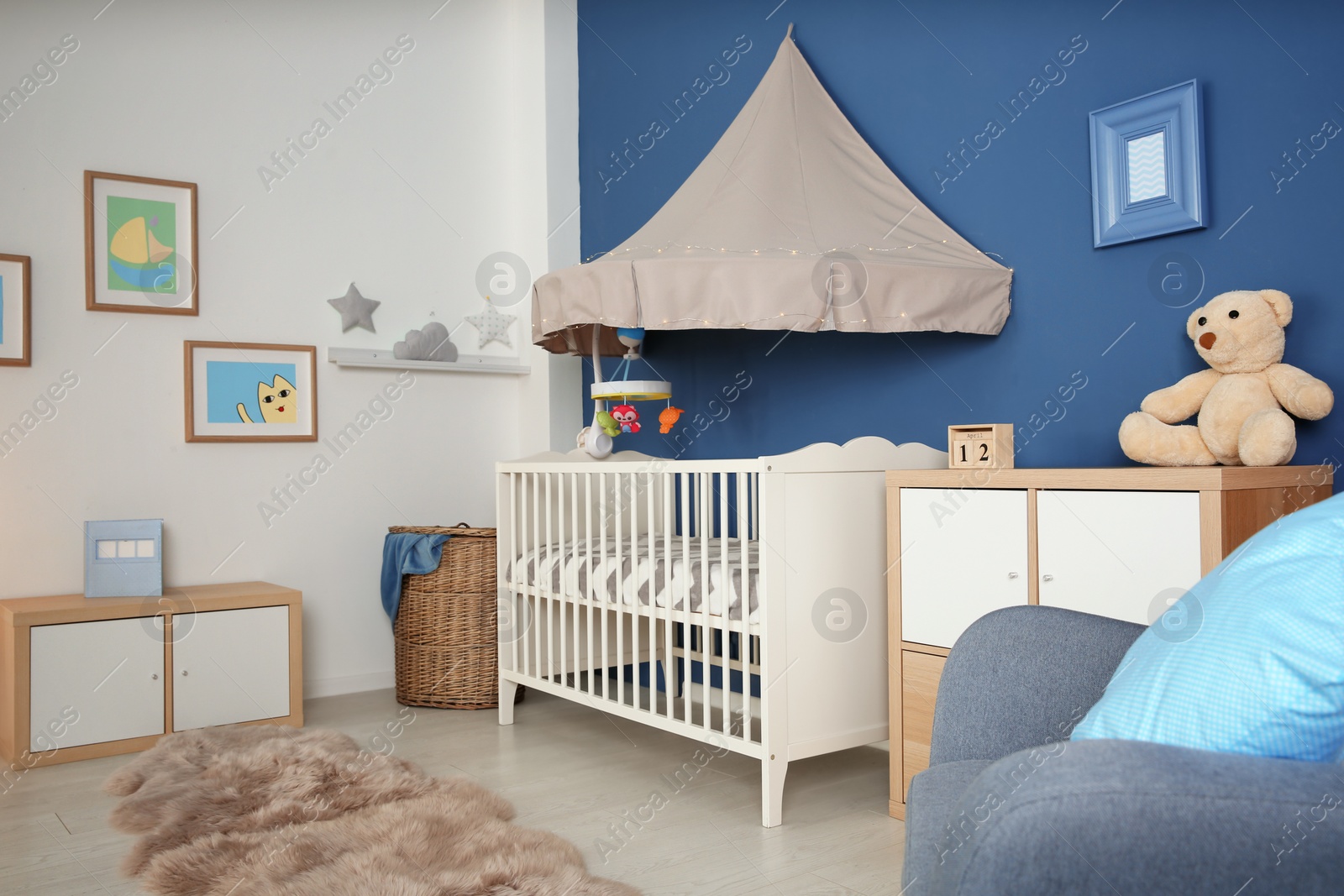 Photo of Stylish baby room interior with crib