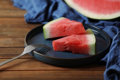 Photo of Sliced fresh juicy watermelon served on wooden table, closeup