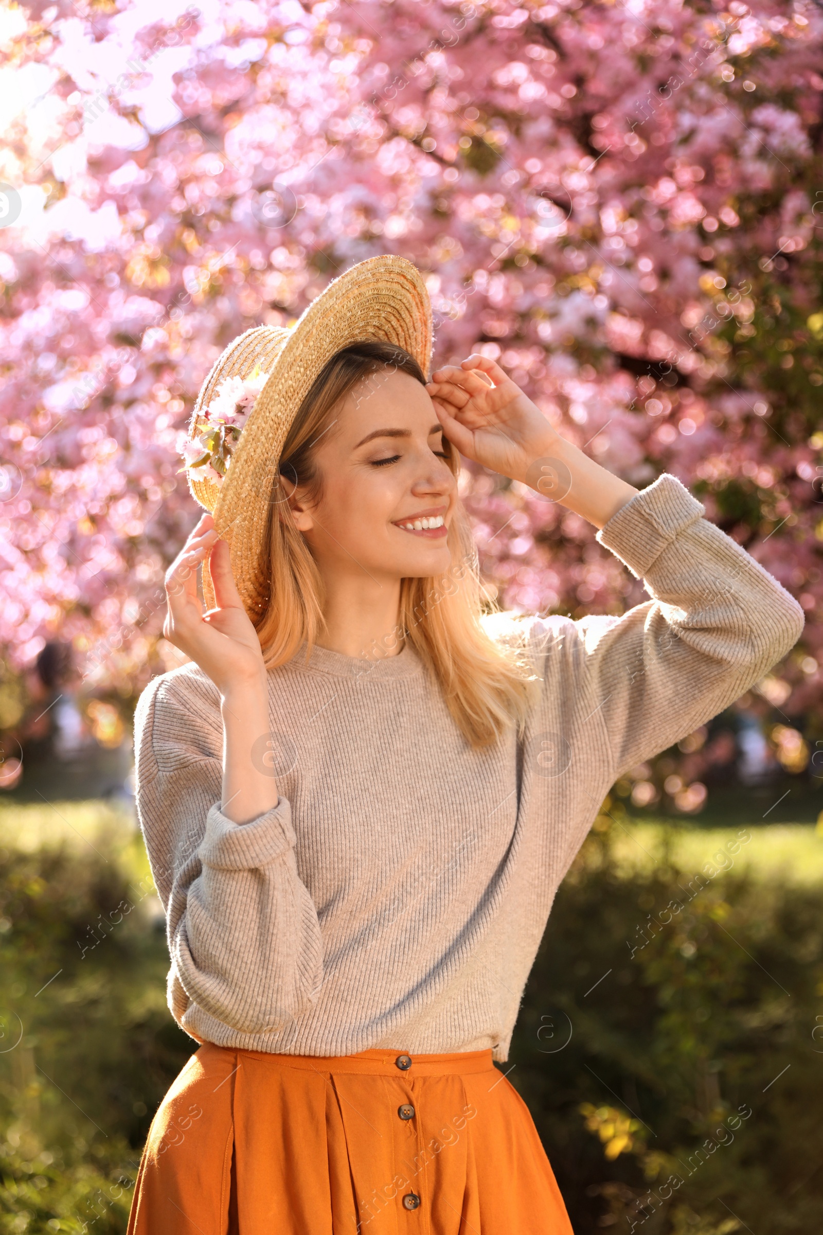 Photo of Young woman wearing stylish outfit in park on spring day. Fashionable look