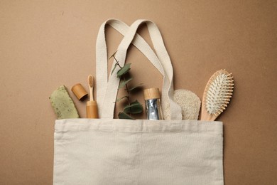 Bag with eco friendly products on craft paper, flat lay