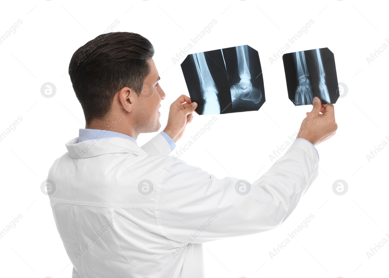 Photo of Orthopedist holding X-ray pictures on white background