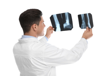 Orthopedist holding X-ray pictures on white background
