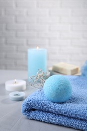 Beautiful composition with aromatic bath bomb on grey table, space for text