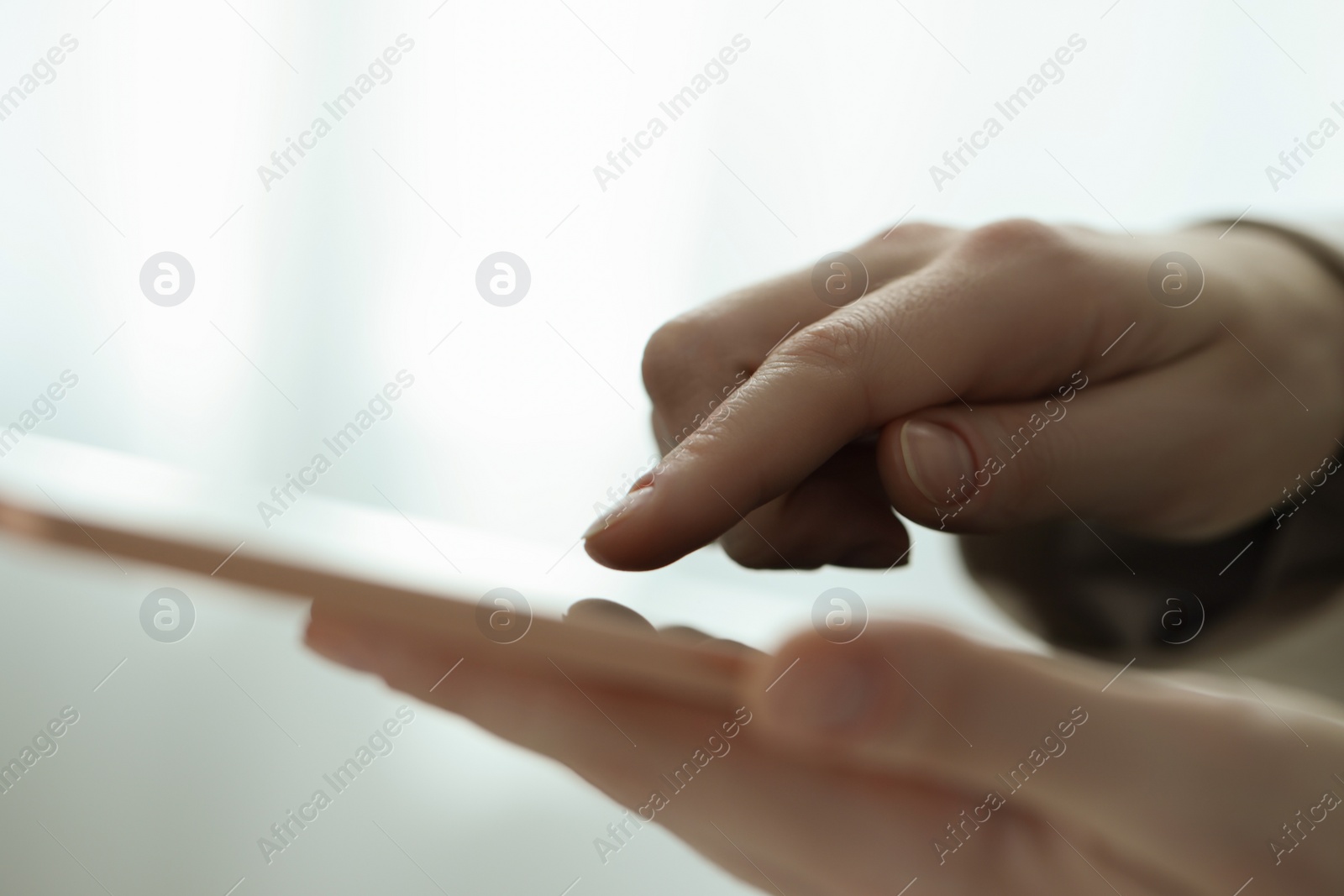 Photo of Closeup view of woman using modern tablet on blurred background