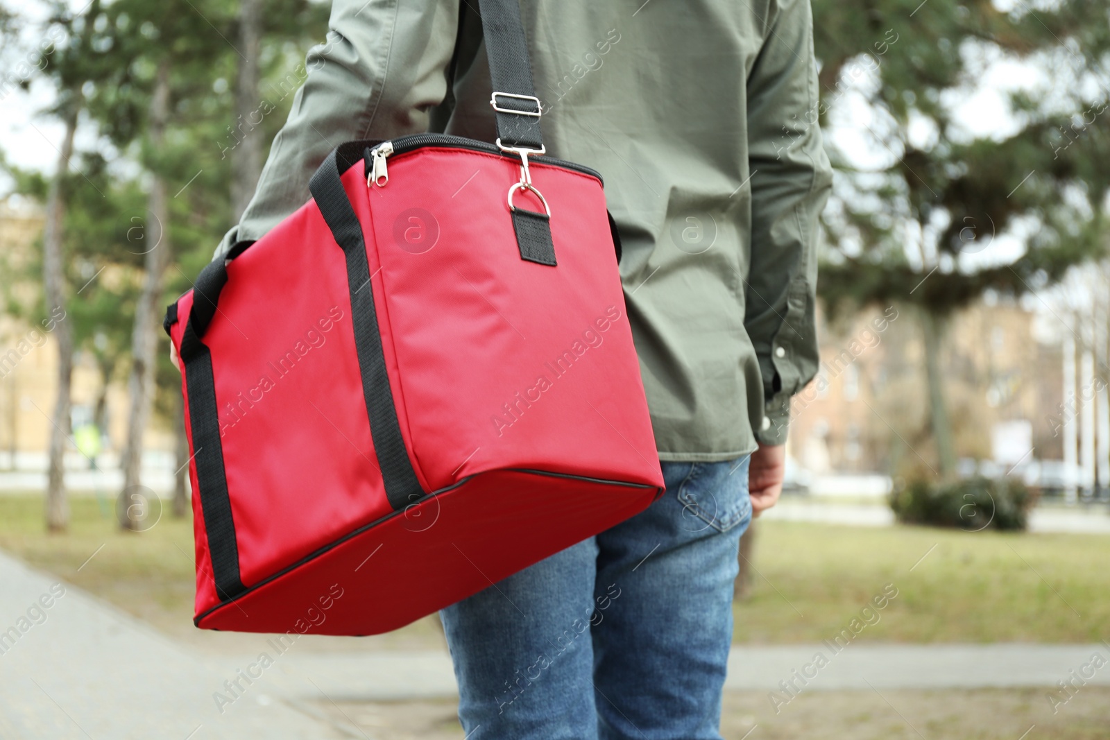 Photo of Courier with thermo bag outdoors, closeup. Food delivery service