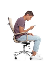 Photo of Man with poor posture using smartphone while sitting in armchair against white background
