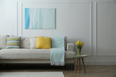 Photo of Stylish beige sofa in living room interior