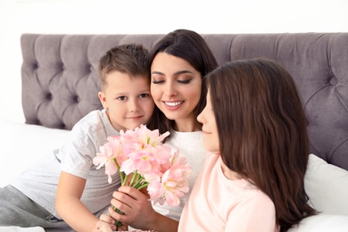 Son and daughter congratulating mom in bed. Happy Mother's Day