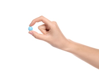 Photo of Woman holding color pill on white background, closeup