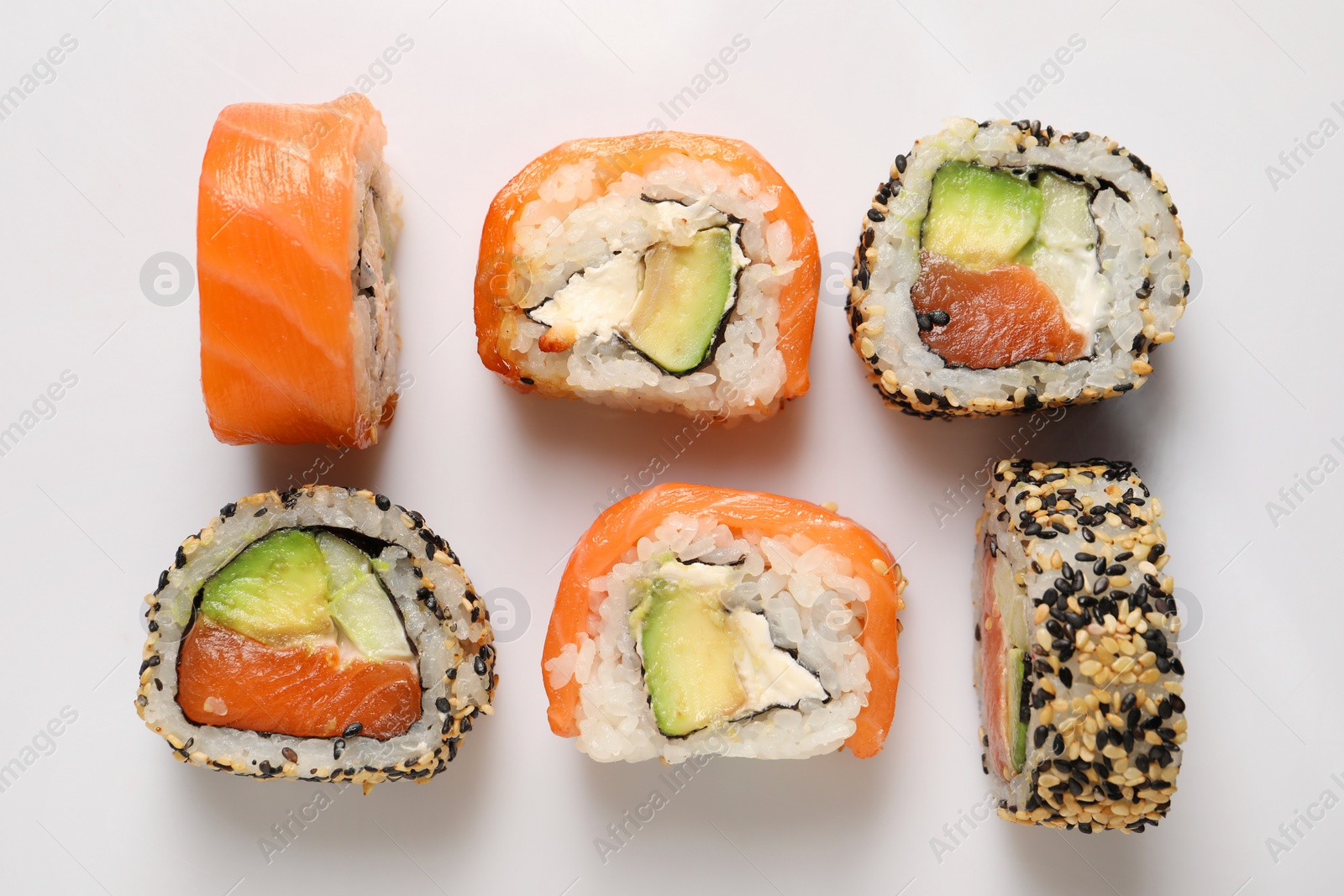 Photo of Delicious sushi rolls on white background, flat lay