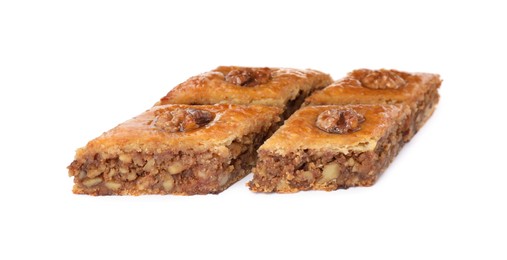 Photo of Delicious honey baklava with walnuts on white background