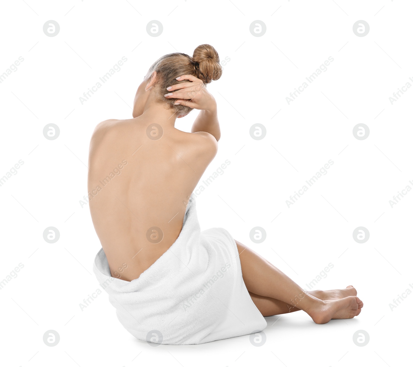 Photo of Young woman with soft towel sitting on white background