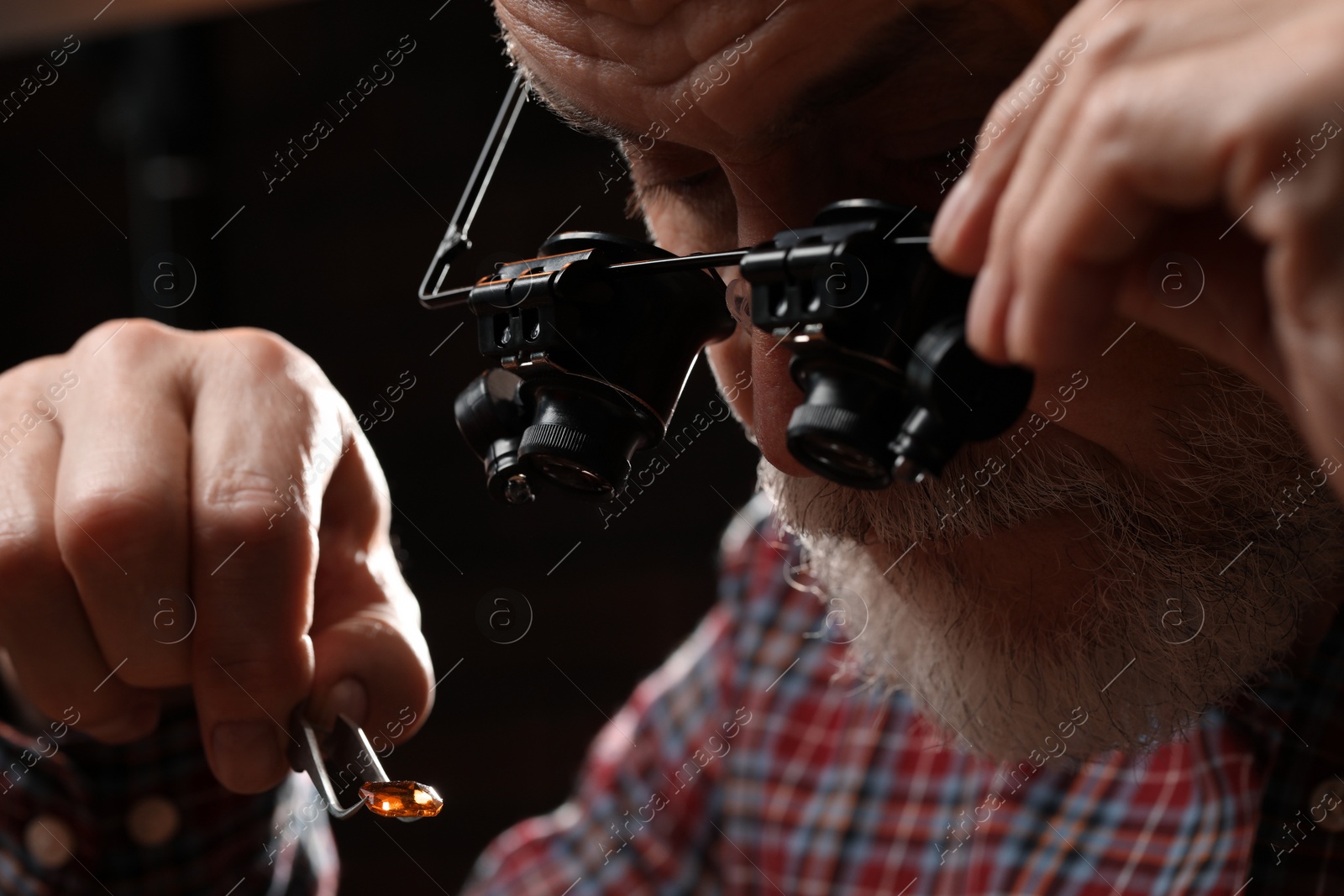 Photo of Professional jeweler working with gemstone, closeup view