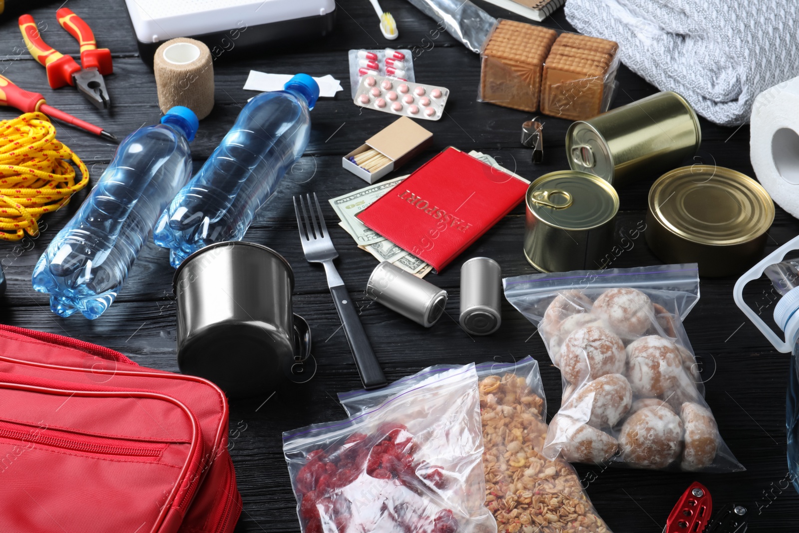 Photo of Disaster supply kit for earthquake on black wooden table