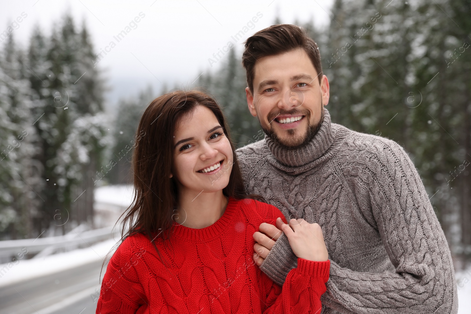 Photo of Cute couple outdoors on snowy day. Winter vacation